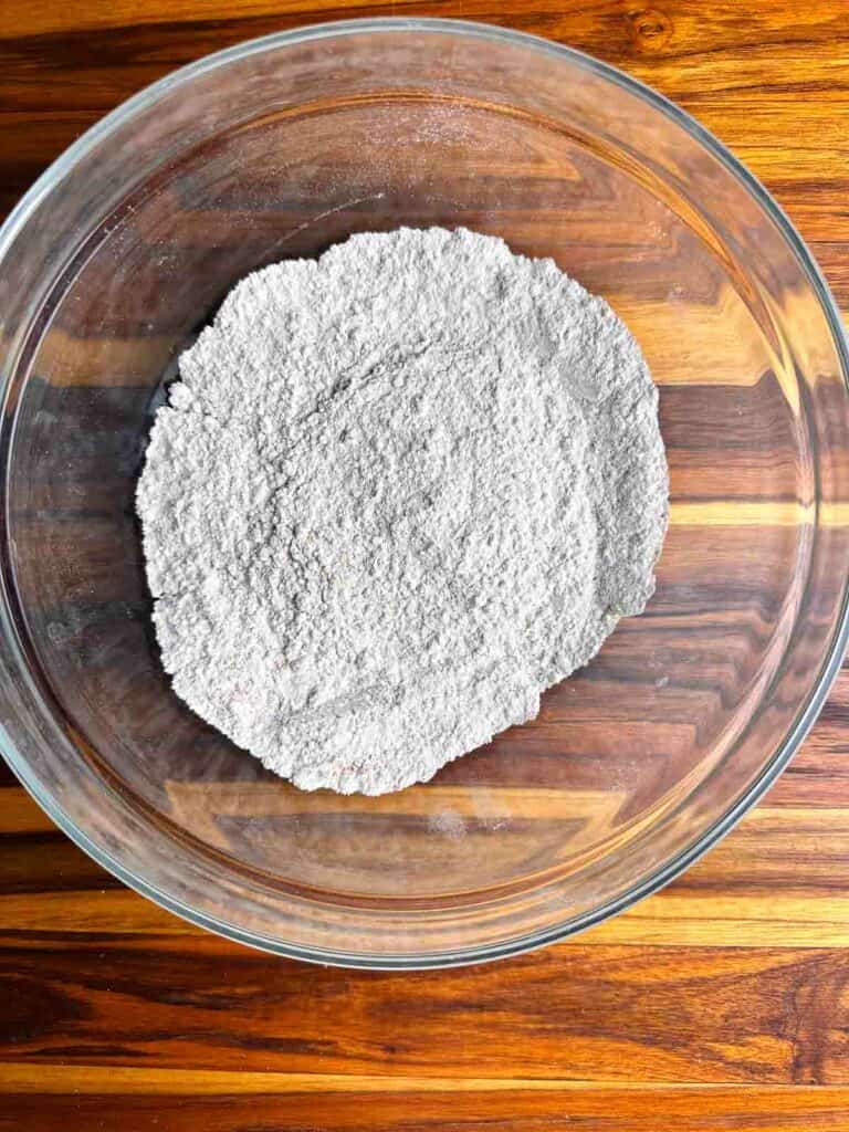 Flour mixture in a bowl for cranberry orange bread.