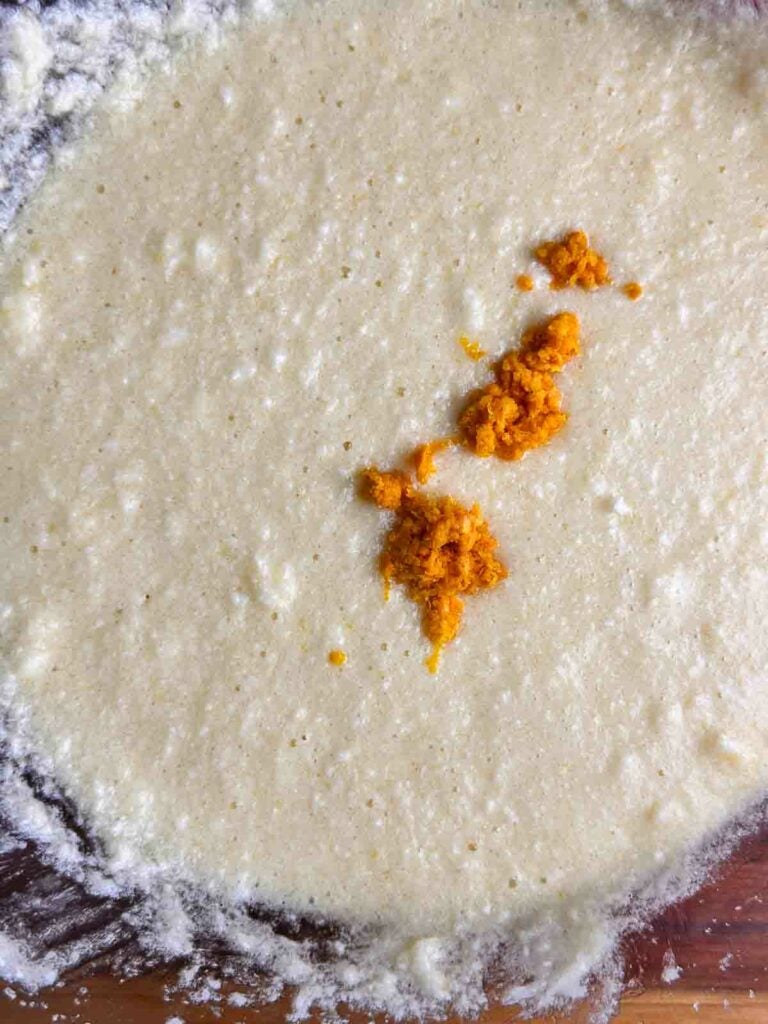 Orange zest on top of a butter mixture.