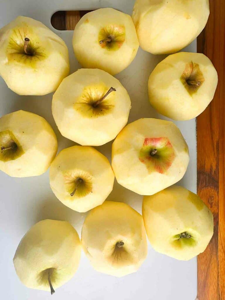 Peeled apples on a cutting board