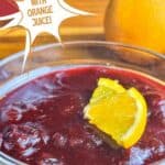 Orange cranberry sauce with orange slices, cinnamon sticks, and cranberries. Text reads: orange cranberry sauce with orange juice, www.seasonedsprinkles.com.