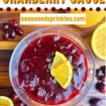 Orange cranberry sauce with orange slices, cinnamon sticks, and cranberries. Text reads: orange cranberry sauce, seasonedsprinkles.com.