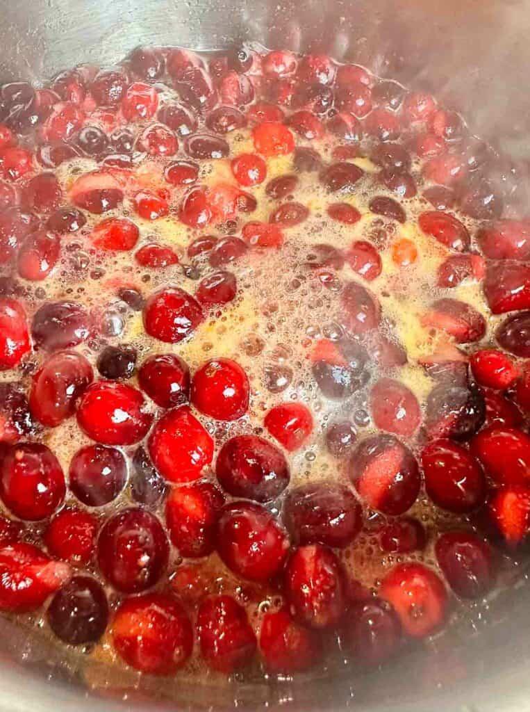 Boiling orange cranberry sauce.