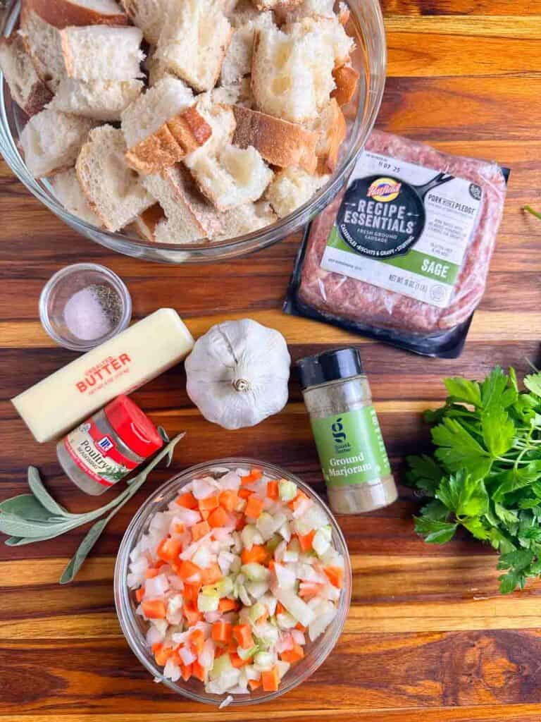 Sausage stuffing recipe ingredients: bread, sausage, salt, pepper, butter, garlic, marjoram, parsley, poultry seasoning, sage, carrots, celery, and onions.