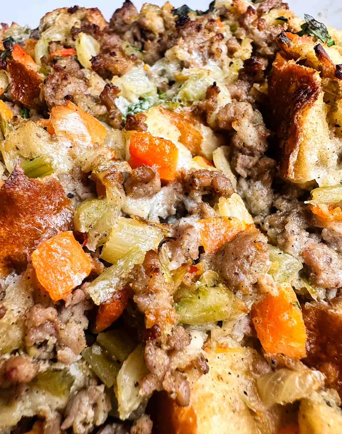 Sausage stuffing close up showing texture of breading, sausage, and veggies.
