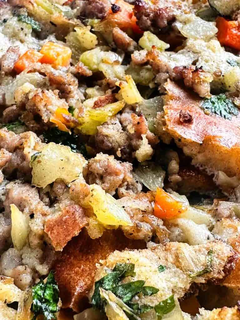 Sausage stuffing close up showing texture of breading, sausage, and veggies.