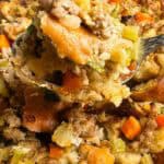 Sausage stuffing being held by a spoon.