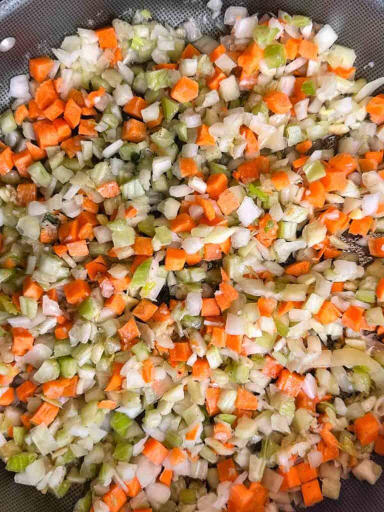 Sautee carrots, celery, and onions for sausage stuffing.