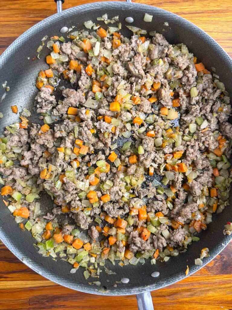 Sausage and veggies ready to mix into the bread for stuffing.