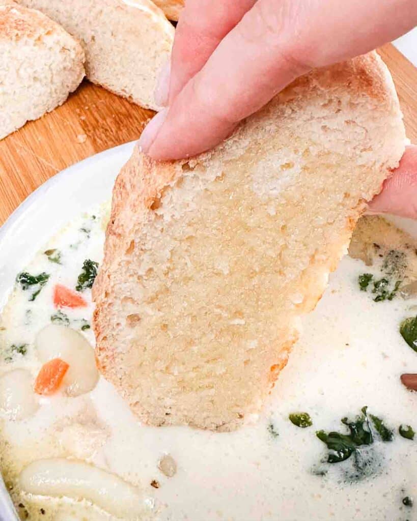 Dipping homemade bread into gnocchi soup.