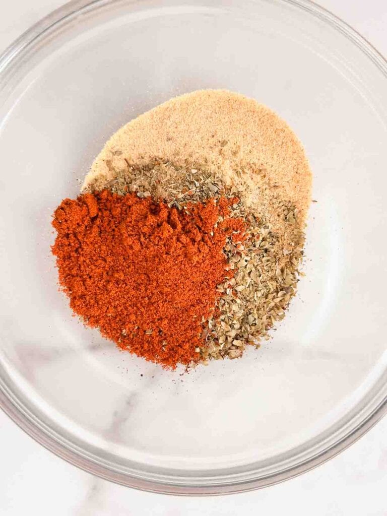 Ingredients for fajita seasoning in a small bowl before mixing.