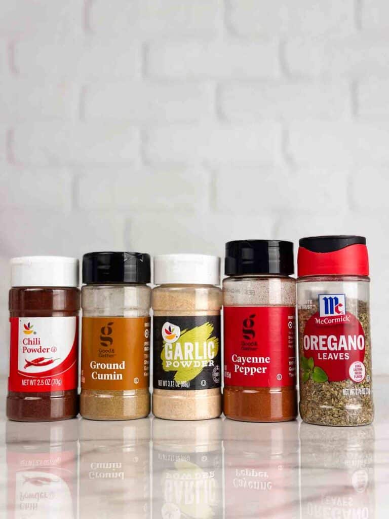 Ingredients for fajita seasoning recipe: chili powder, ground cumin, garlic powder, cayenne pepper, and oregano.