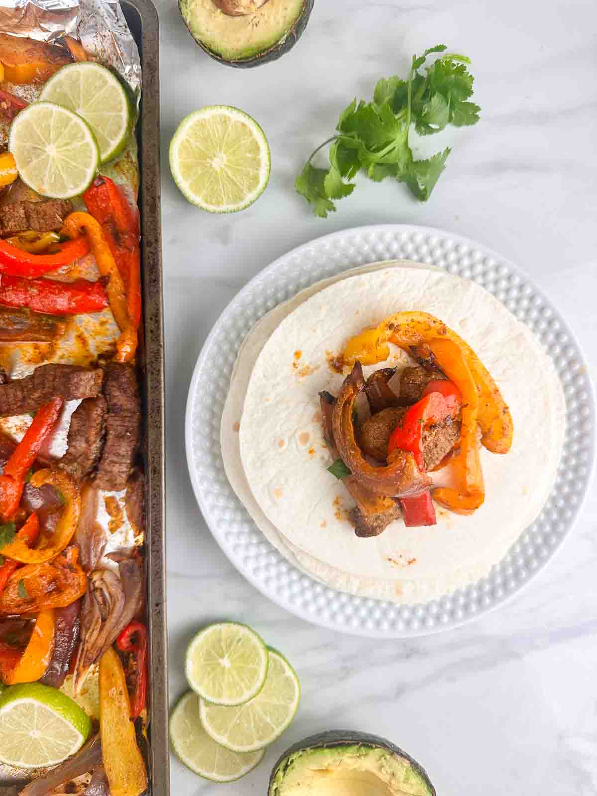 Steak pan steak fajitas plated and still in the pan.