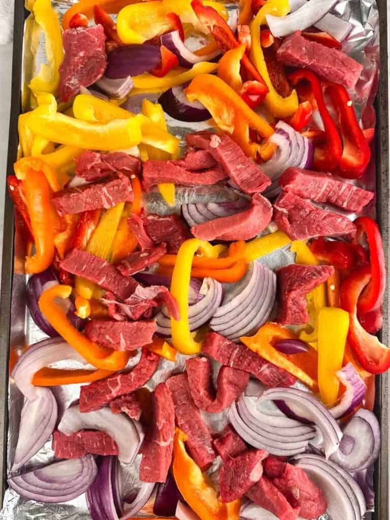 Peppers, steak, and onions ready to bake into a fajita.