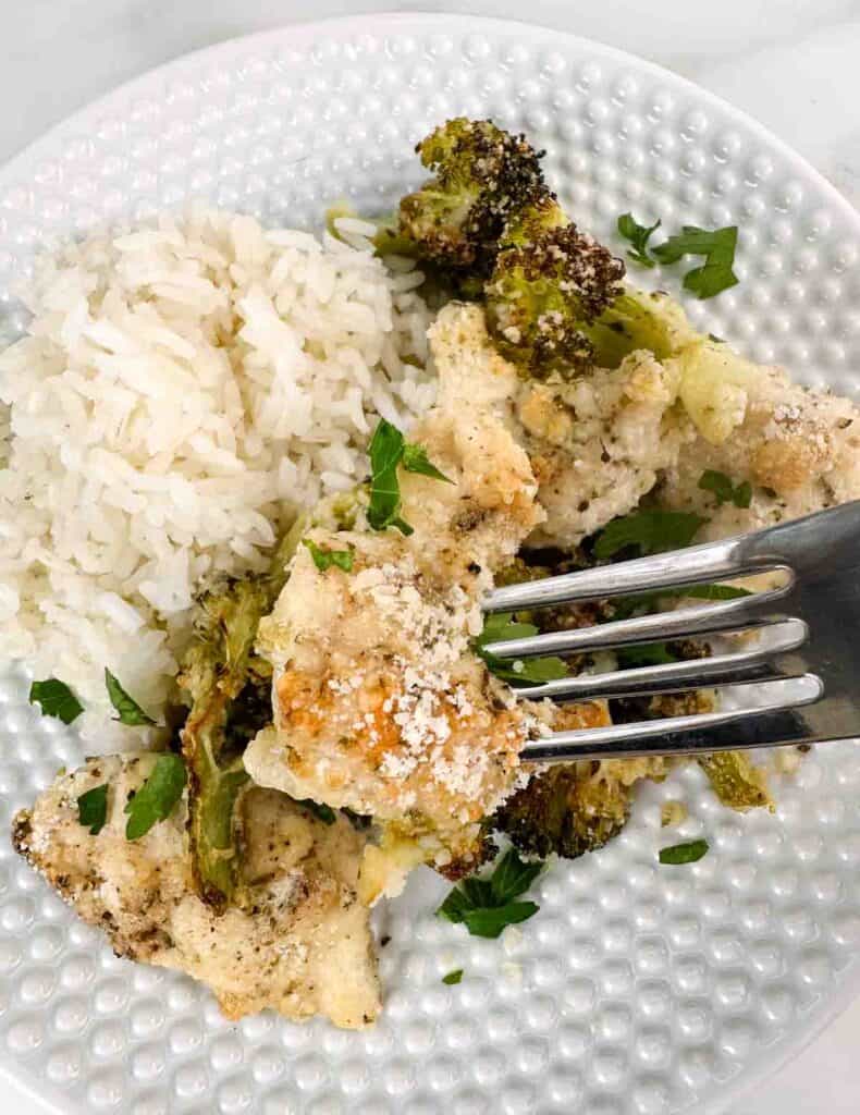 A forkful of sheet pan chicken and broccoli