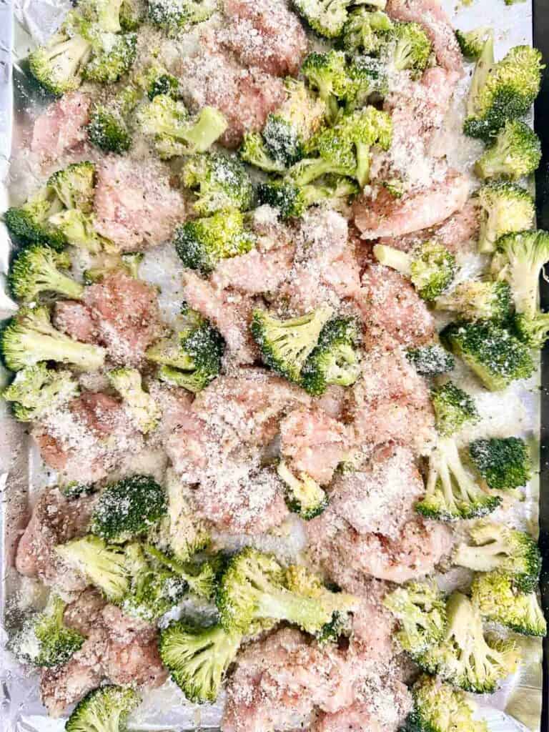 Coat the chicken and broccoli in olive oil, spices, and Parmesan cheese
