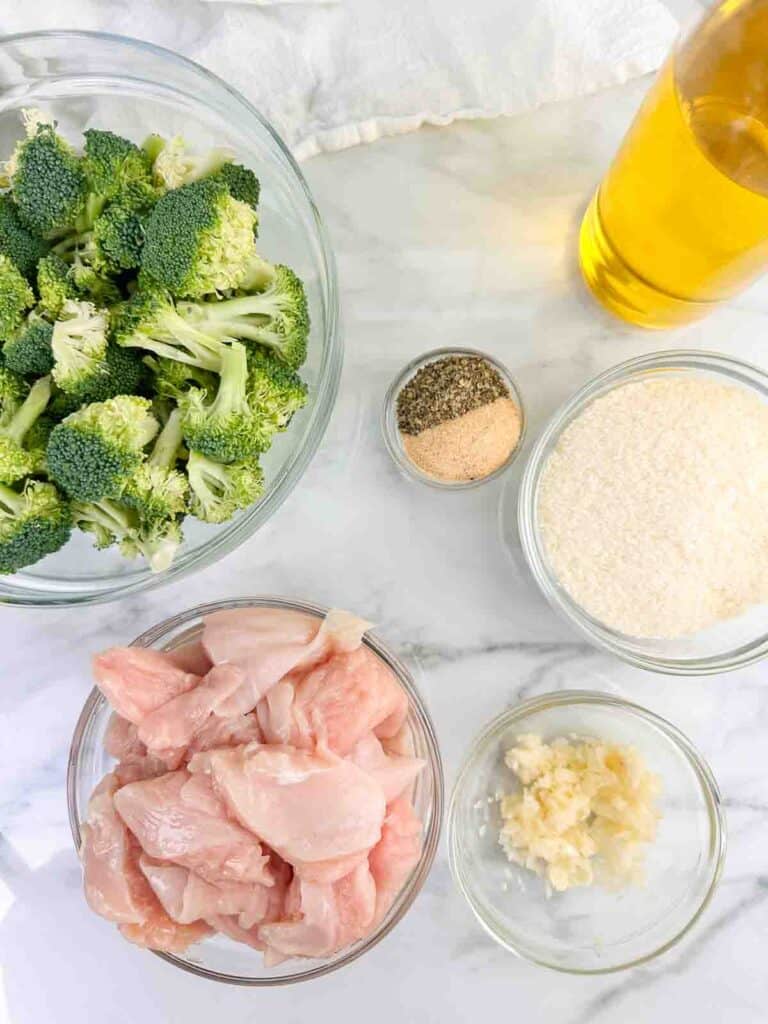 Ingredients for Sheet Pan Chicken and Broccoli: Chicken, Broccoli, Spices, Olive Oil, Garlic, and Parmesan Cheese
