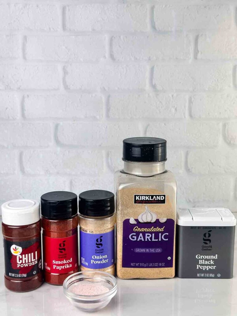 Ingredients for a hamburger seasoning recipe: chili powder, smoked paprika, onion powder, garlic powder, ground black pepper, and sea salt.