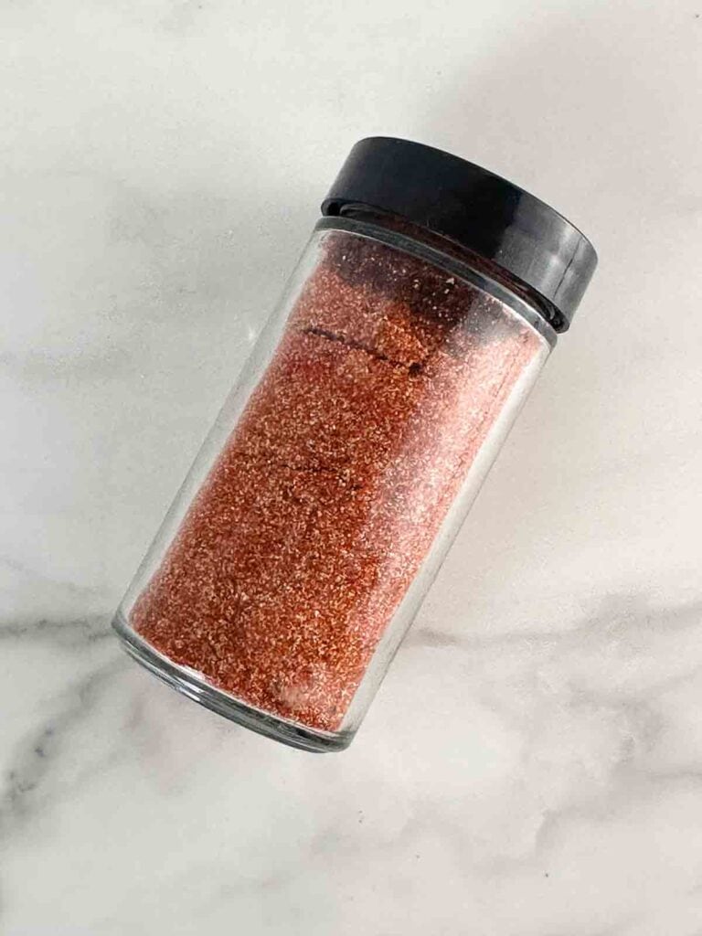 Container of homemade burger seasoning.