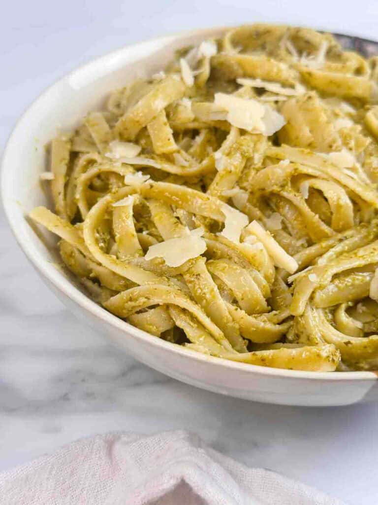 Bowl of pasta with creamy pesto sauce.