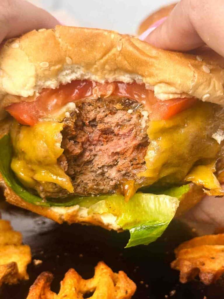 a bite of a homemade cheeseburger