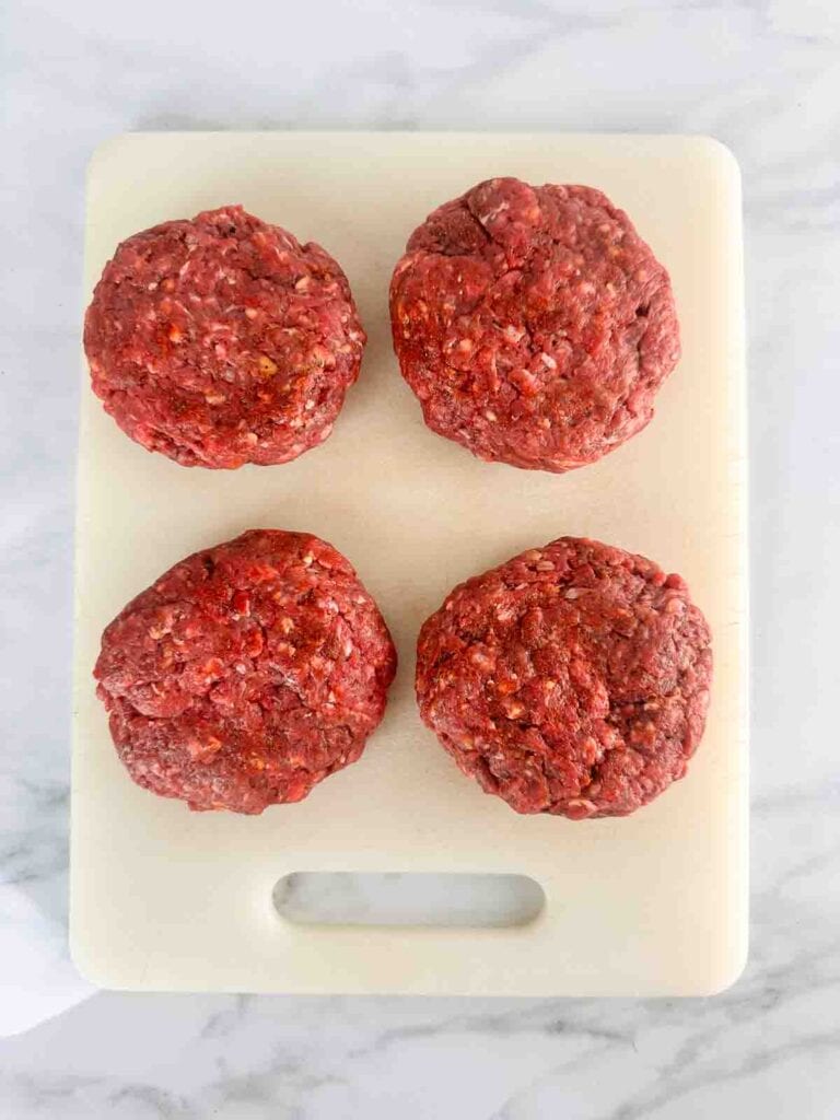 The seasoned beef formed into 4 patties