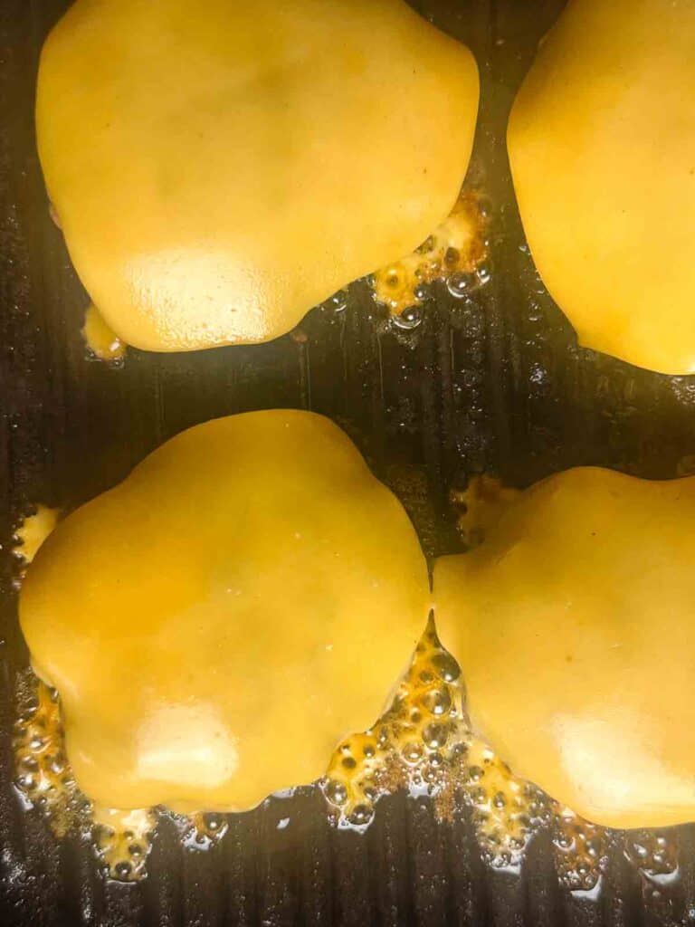 Melt cheese onto the burgers