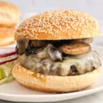 Mushroom burger with a sesame seed bun, ready to eat.