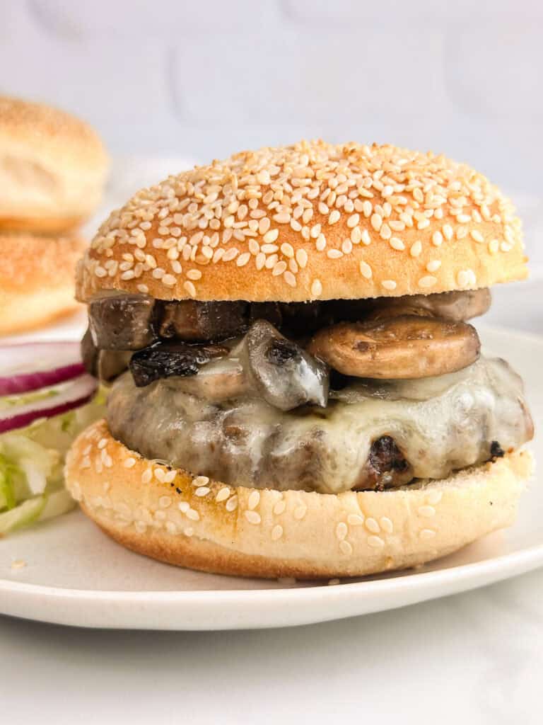 Mushroom burger with a sesame seed bun, ready to eat.