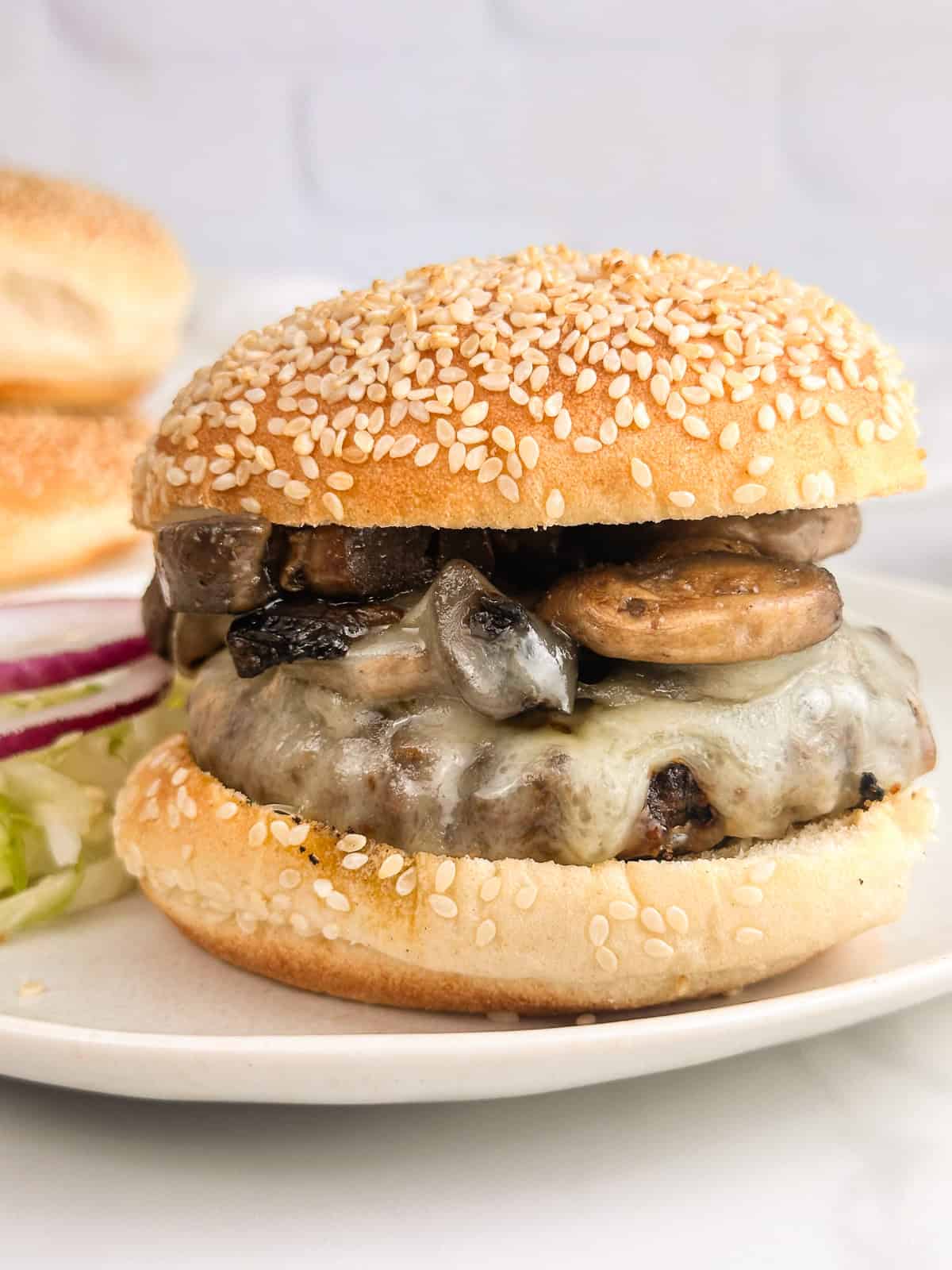 Mushroom burger with a sesame seed bun, ready to eat.